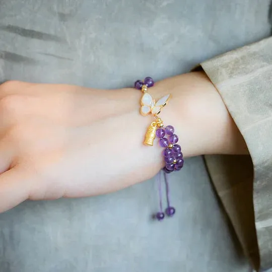 Handmade purple amethyst crystal bracelet with multi-treasure natural stone beads on white background
