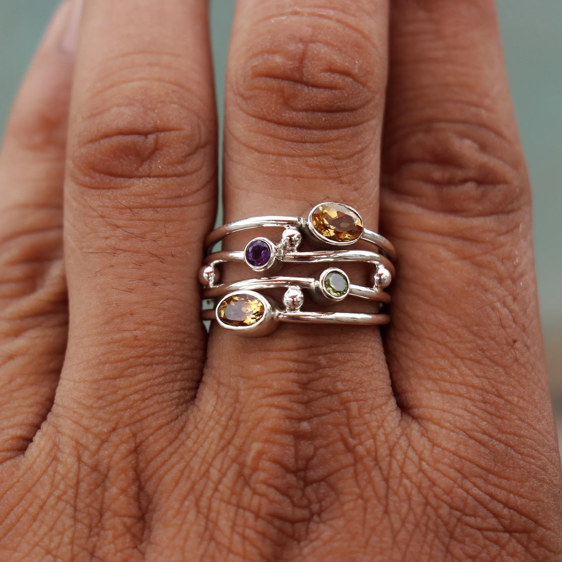 Silver bohemian diamond studded hollow copper ring with geometric ellipse shape on plain background