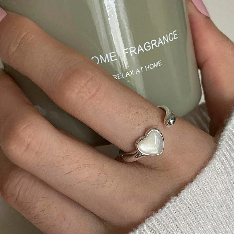 Adjustable copper love heart-shaped ring with electroplated finish on white background