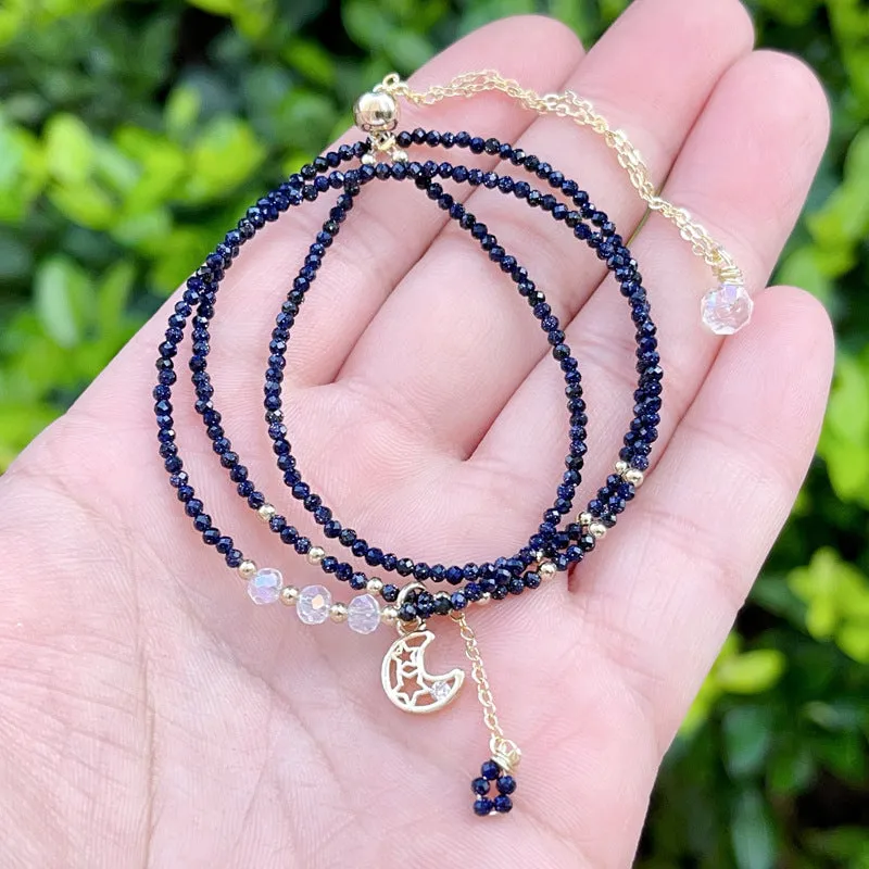Close-up of a blue gold sand stone bracelet with three interlocking rings on a wrist.