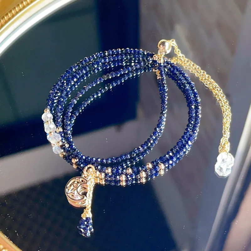 Close-up of a blue gold sand stone bracelet with three interlocking rings on a wrist.