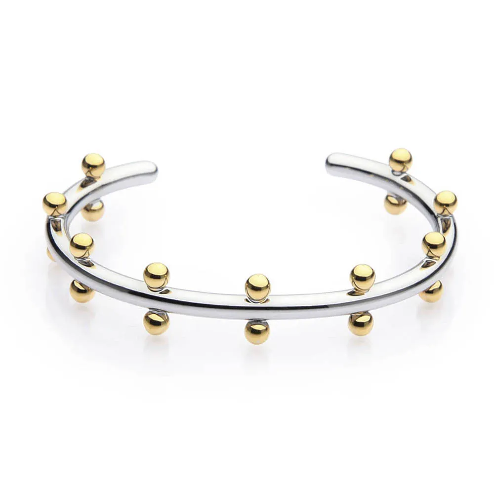 Stainless steel C-shaped bean beads with textured rivet design in gold, steel, and steel gold colours next to an alloy bracelet.
