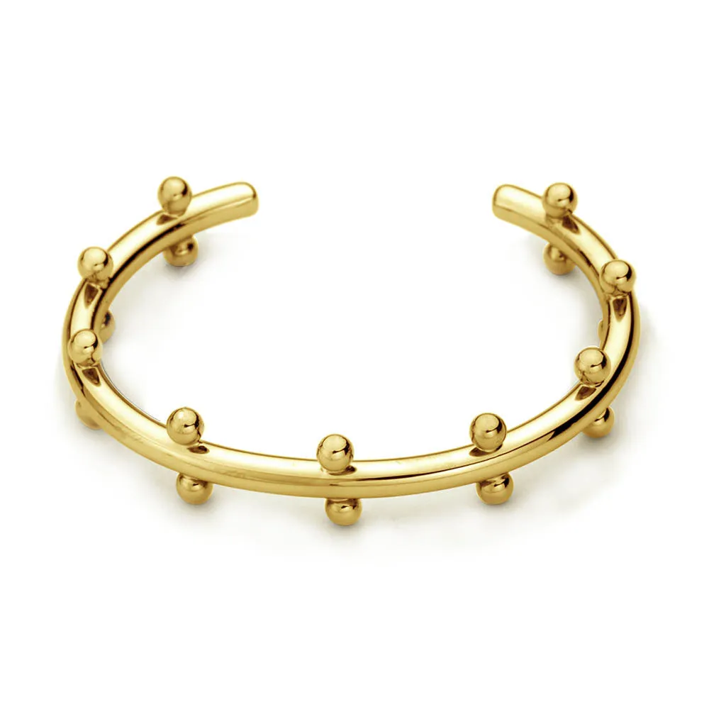 Stainless steel C-shaped bean beads with textured rivet design in gold, steel, and steel gold colours next to an alloy bracelet.