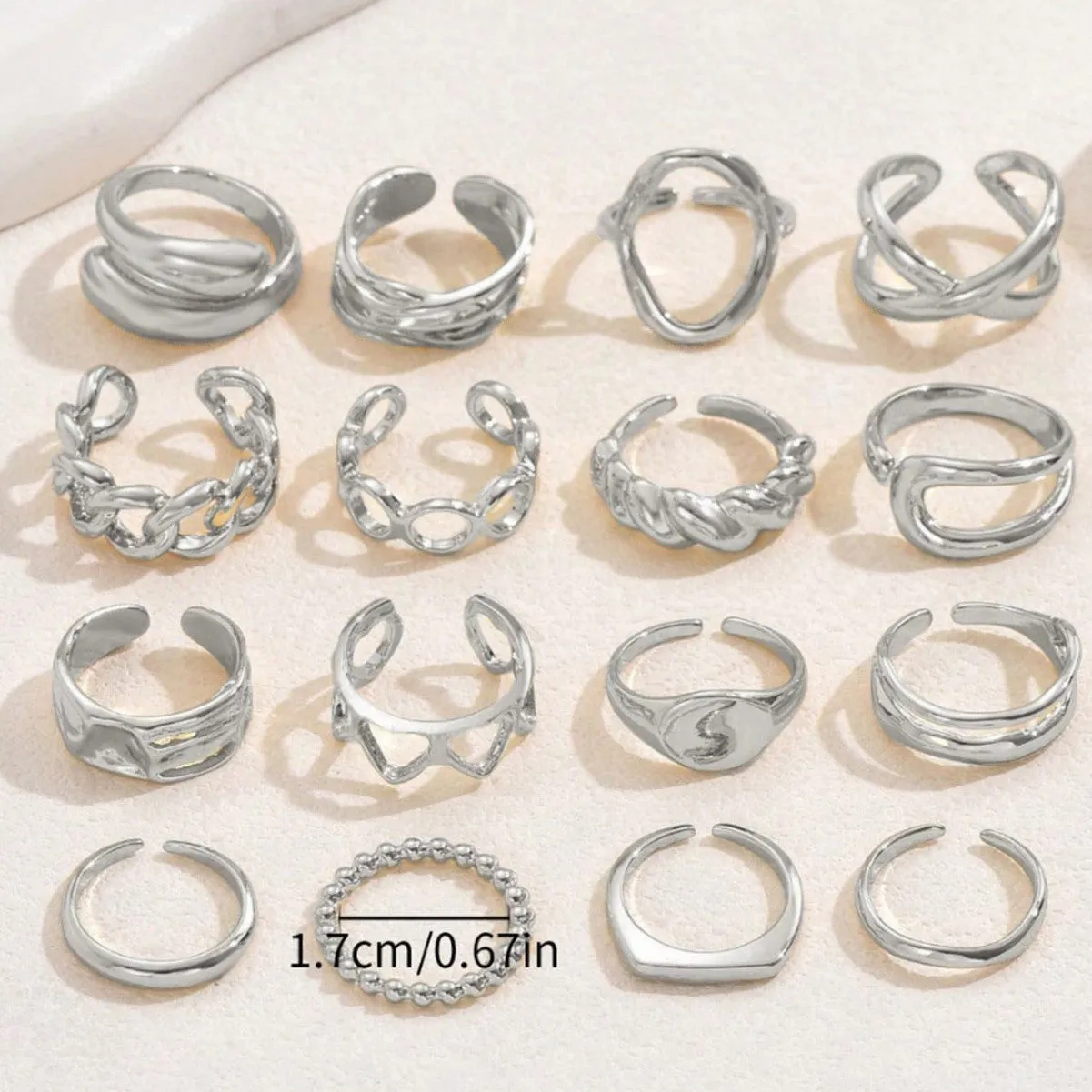 Women's 16-piece open ring suit in silver and gold zinc alloy geometric shape on display