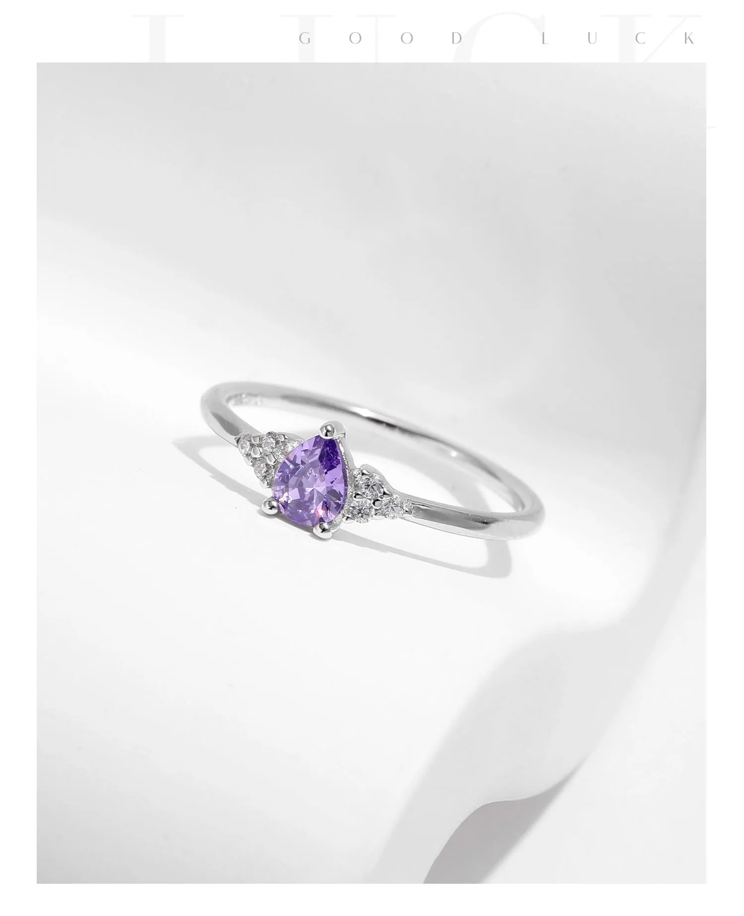 S925 sterling silver ring with purple crystal drop-shaped rhinestone on white background