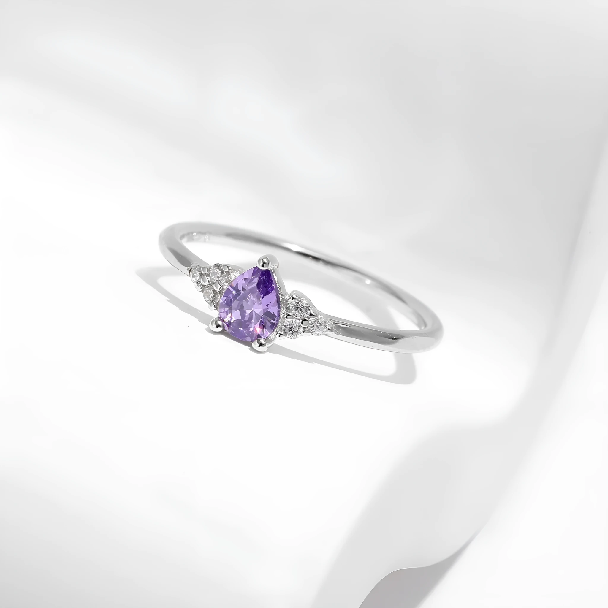S925 sterling silver ring with purple crystal drop-shaped rhinestone on white background