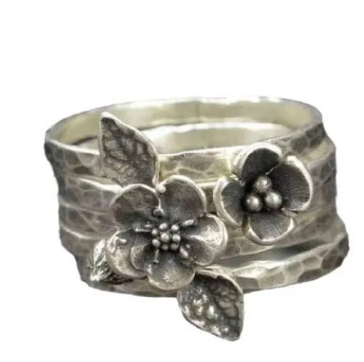 Silver alloy ring with carved honeycomb bee pattern in flower shape on white background