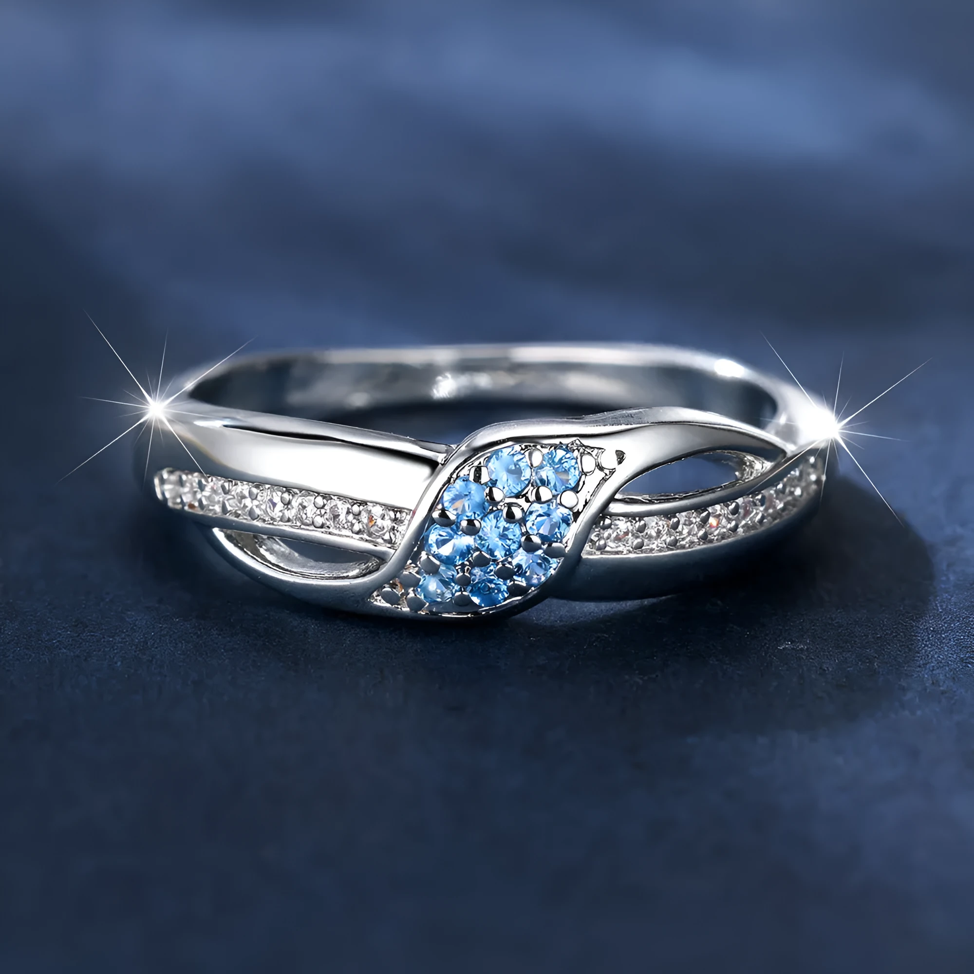 Women's ring with sea blue diamond edge inlay and white diamond leaf accents on white K plated copper band, simple geometric style