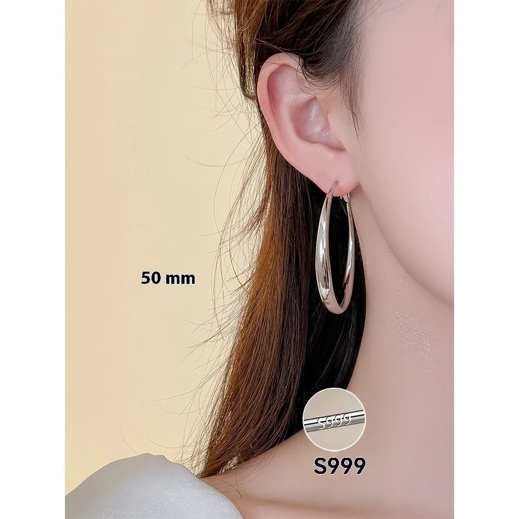 Silver needle big circle bracelet and earrings set with electroplated platinum finish on light background, three size options