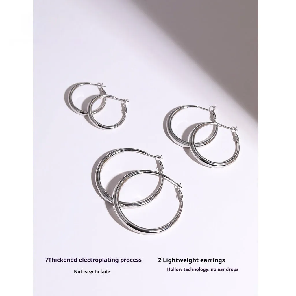 Silver needle big circle bracelet and earrings set with electroplated platinum finish on light background, three size options