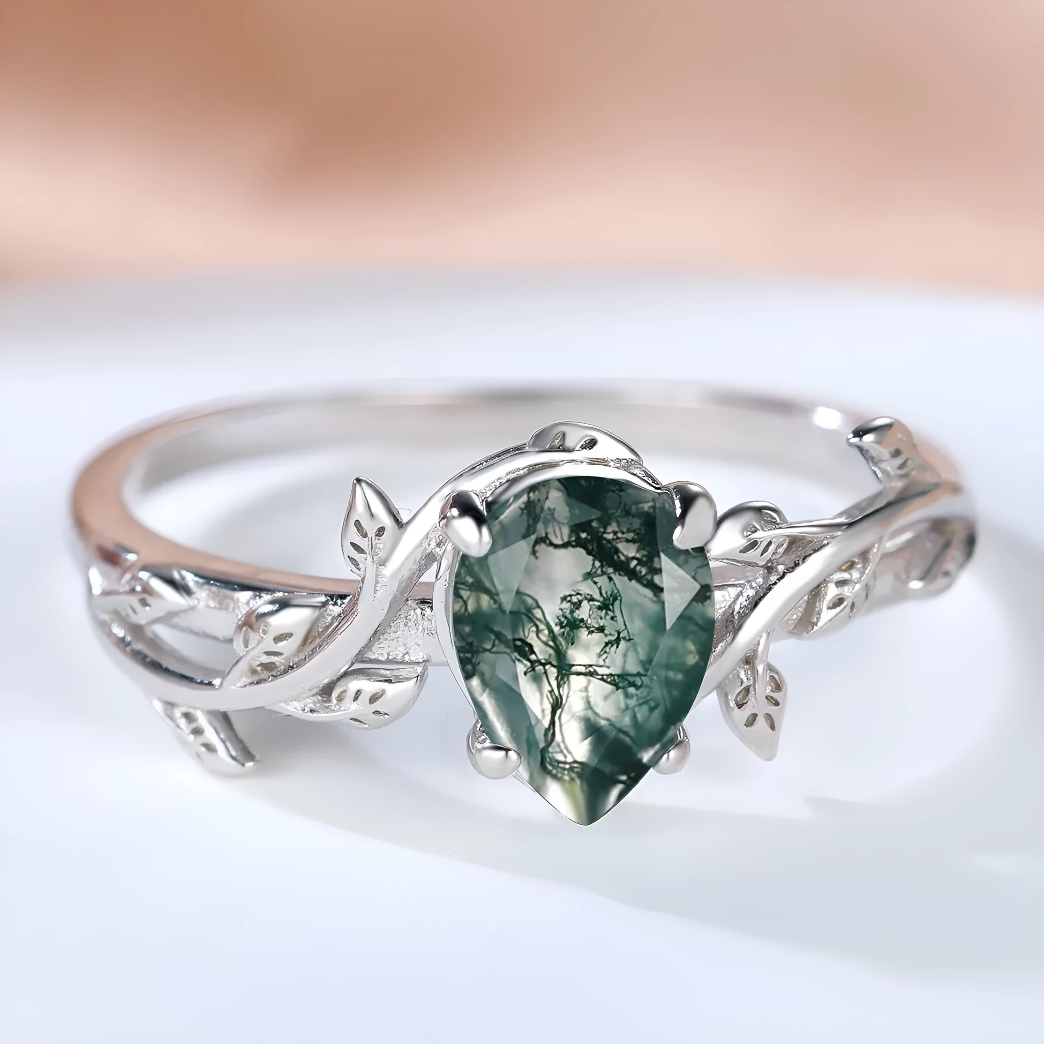 S925 silver drop-shaped agate edge branch leaf ring on white background, sterling silver band with natural stone