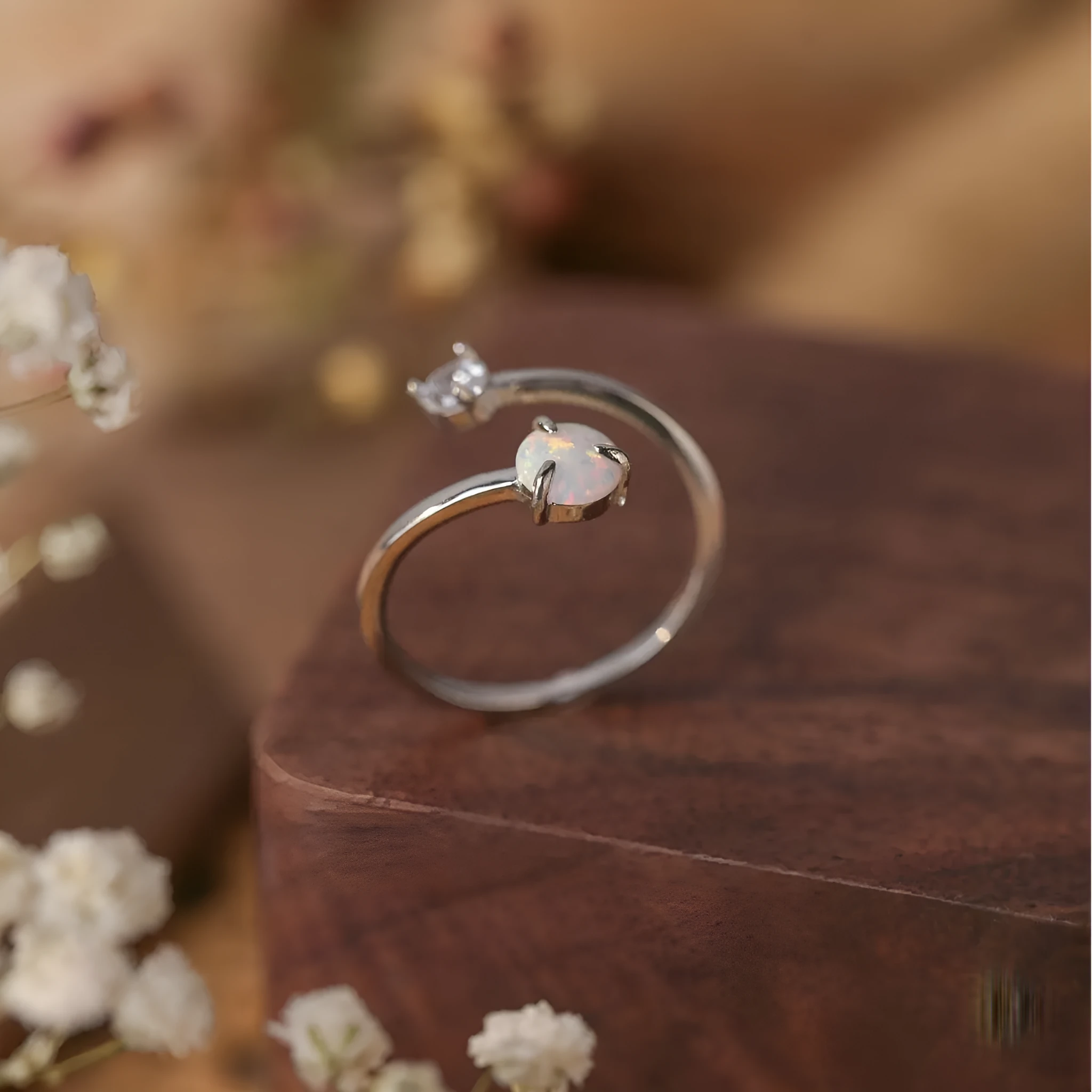 Open ring with adjustable opening, silver band, and inlaid zircon stones in gold colour
