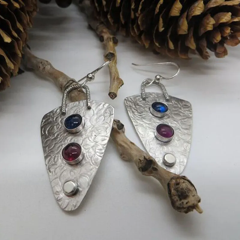 Coloured glaze electroplated metal earrings for women, silver colour, one pair shown on white background