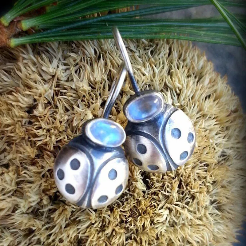 Coloured glaze electroplated metal earrings for women, silver colour, one pair shown on white background