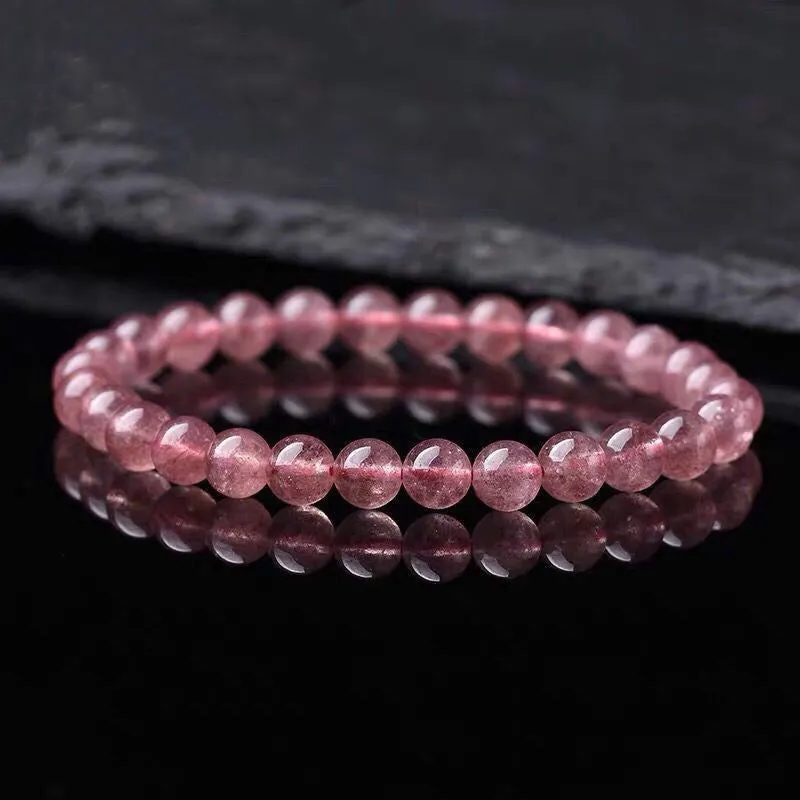 Women's strawberry quartz crystal bracelet with polished beads in 6mm, 8mm, or 10mm sizes.