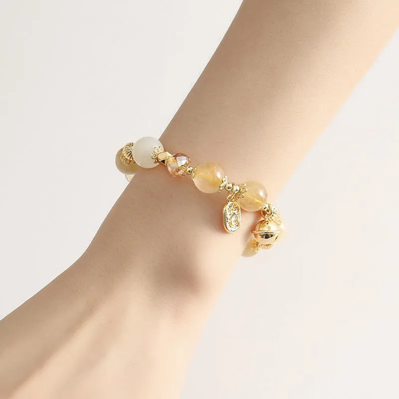 Adjustable gold tone bracelet with rutilated quartz crystal centrepiece and electroplated metal components