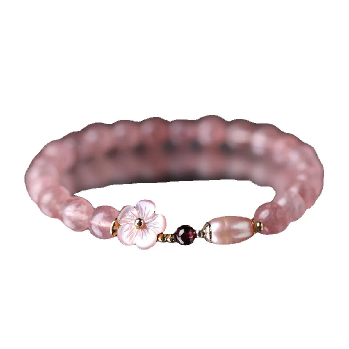 Women's strawberry quartz crystal bracelet with peach blossom flower bead design on wrist