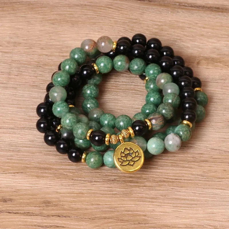 Green and black elastic beaded bracelet with alloy construction