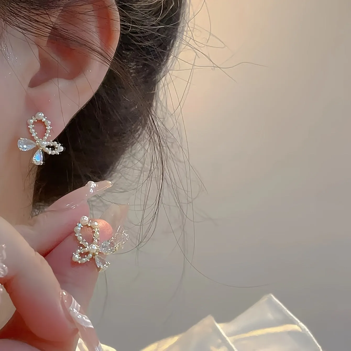 Silver electroplated copper butterfly earrings with geometric accents on a white background