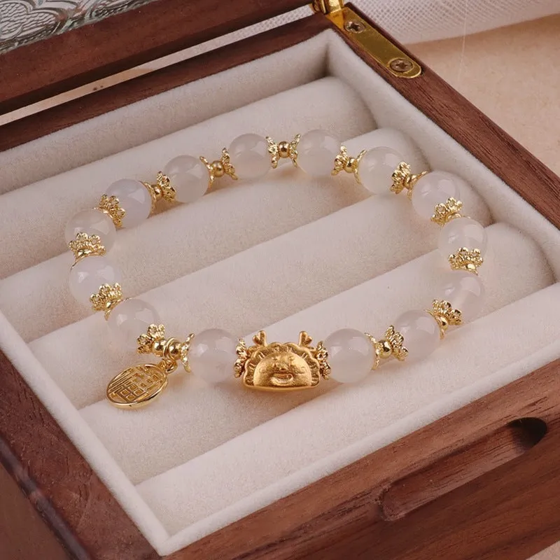 Women's floral glazed bracelet with animal zodiac motifs on coloured glass beads in red, pink, and white variants