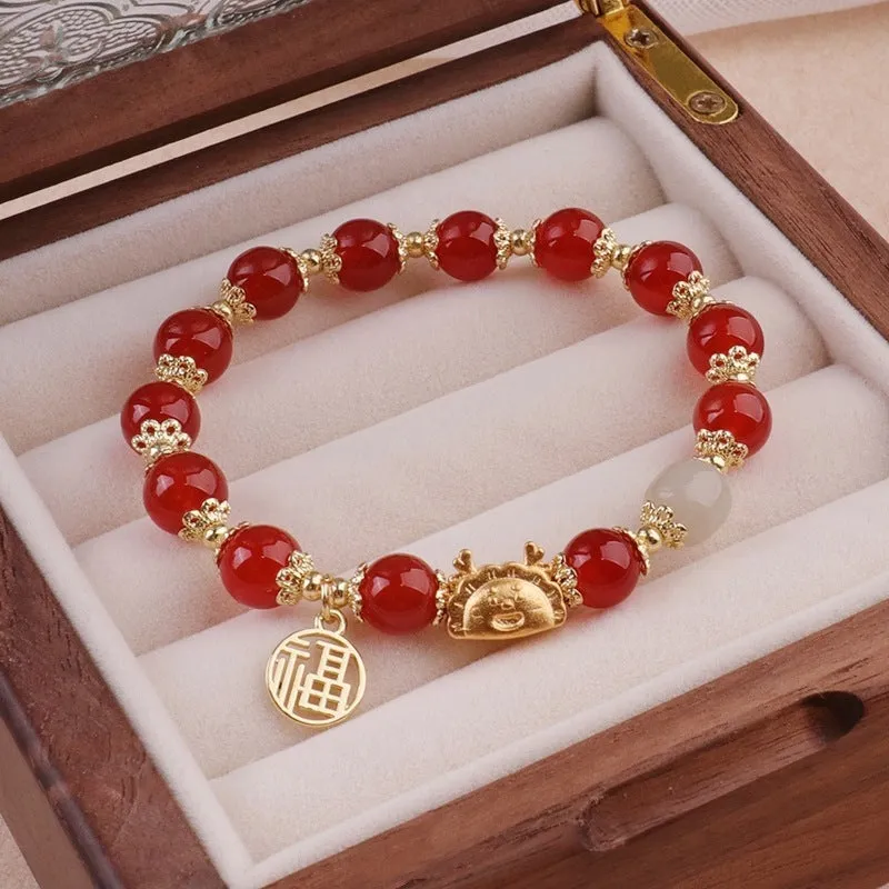 Women's floral glazed bracelet with animal zodiac motifs on coloured glass beads in red, pink, and white variants