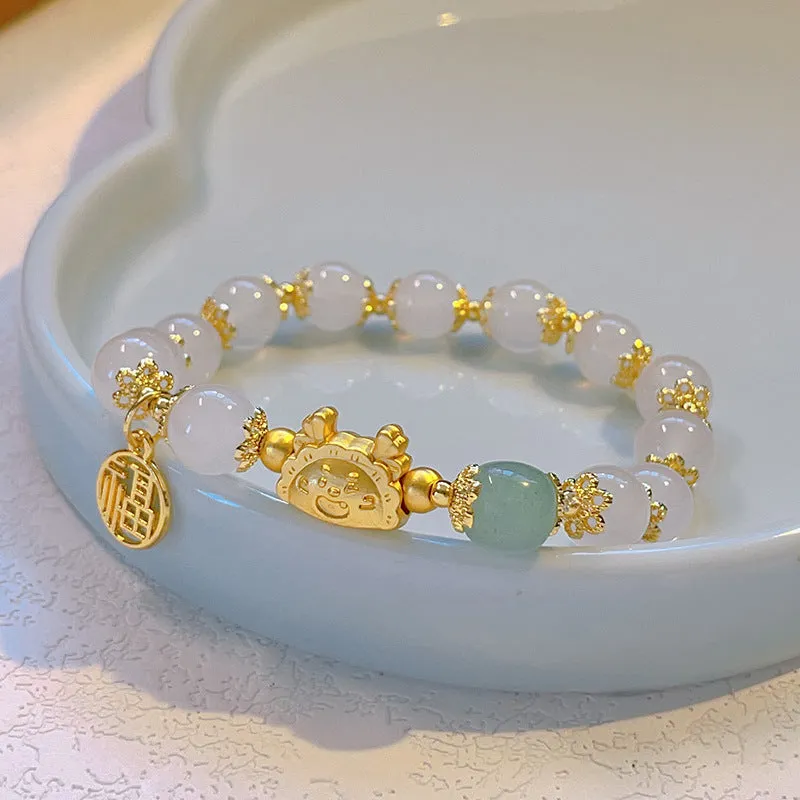 Women's floral glazed bracelet with animal zodiac motifs on coloured glass beads in red, pink, and white variants