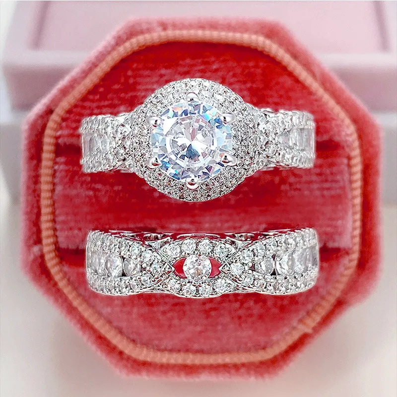 Pair of white gold colour copper couple rings with inlaid zircon stones, geometric U-shaped design on white background