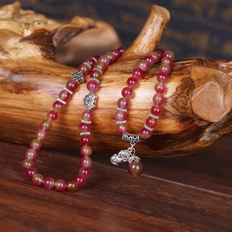 Natural watermelon crystal bracelet with Chinese knot design showing elephant style beads