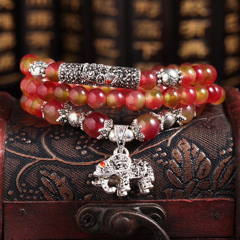 Natural watermelon crystal bracelet with Chinese knot design showing elephant style beads