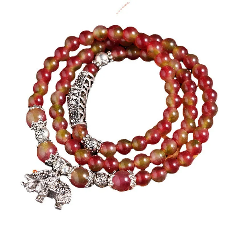 Natural watermelon crystal bracelet with Chinese knot design showing elephant style beads
