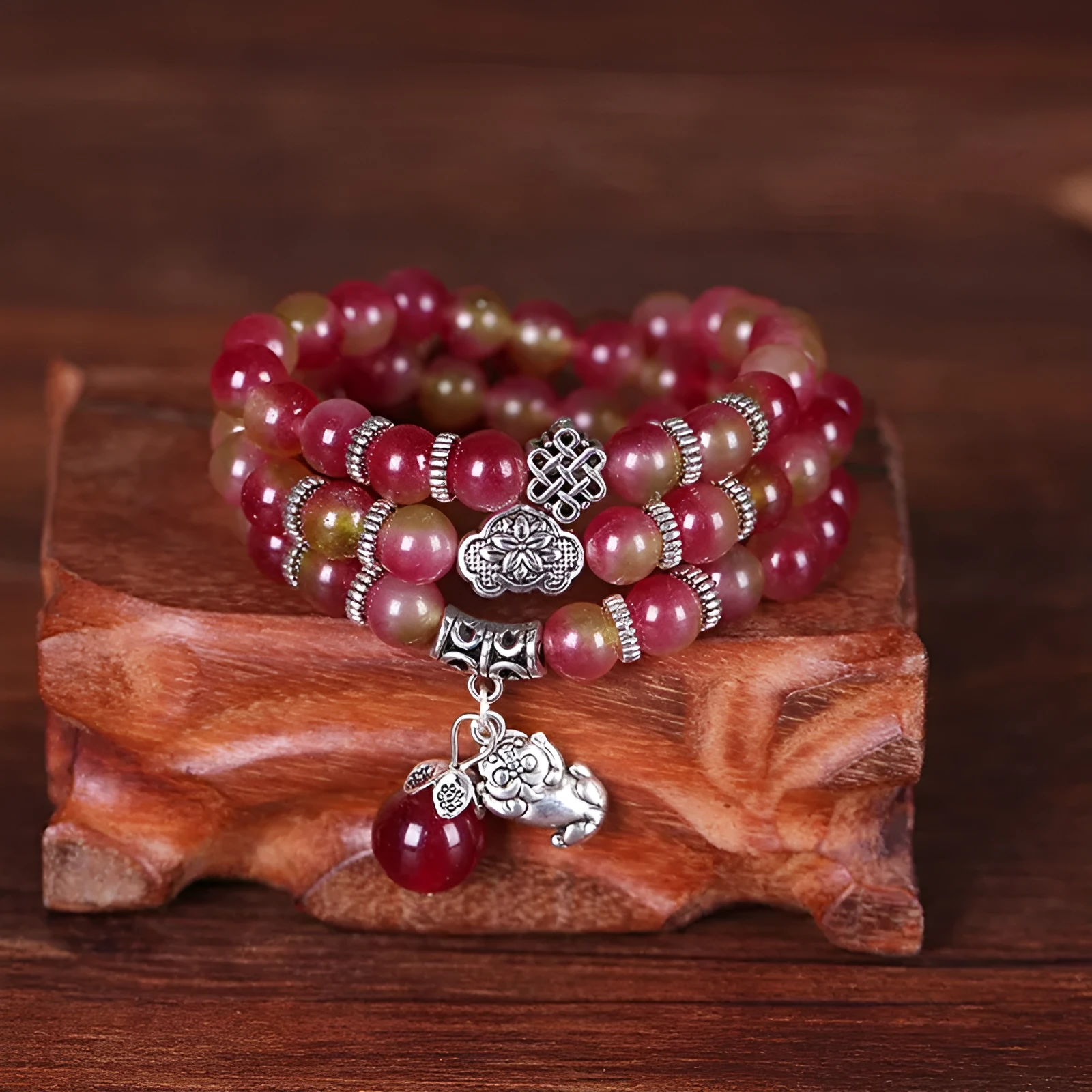 Natural watermelon crystal bracelet with Chinese knot design showing elephant style beads