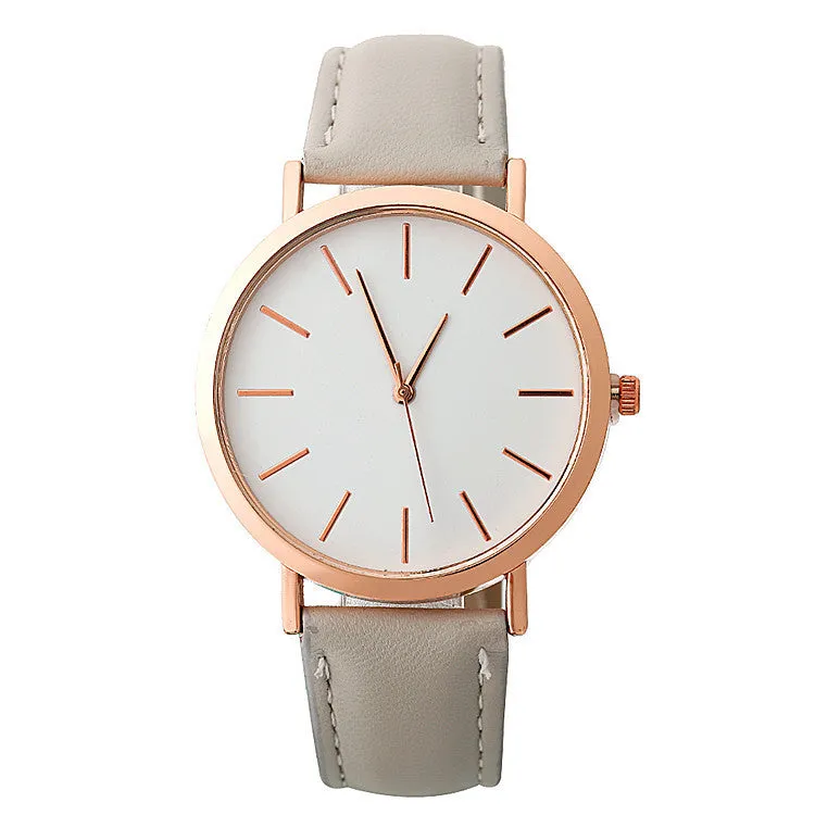 Women's quartz wristwatch round dial 28mm thin case beige strap on white background