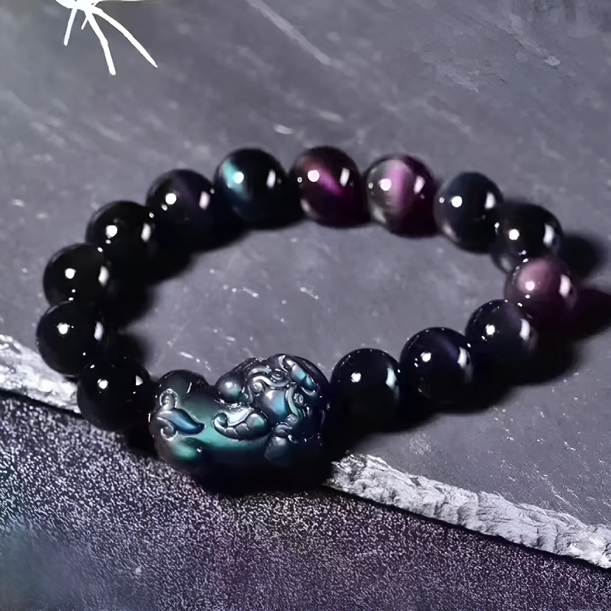 Natural ice colour eye obsidian crystal bracelet with spherical beads on a string.