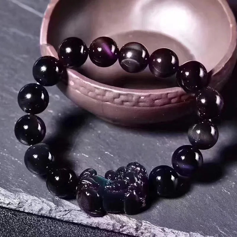 Natural ice colour eye obsidian crystal bracelet with spherical beads on a string.