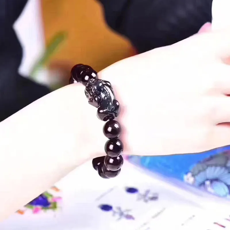 Natural ice colour eye obsidian crystal bracelet with spherical beads on a string.