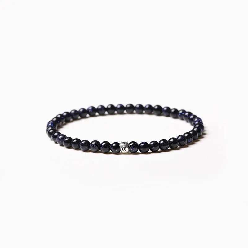 Geometric unisex bracelet with 4mm black agate, blue san, and obsidian beads on a wrist.