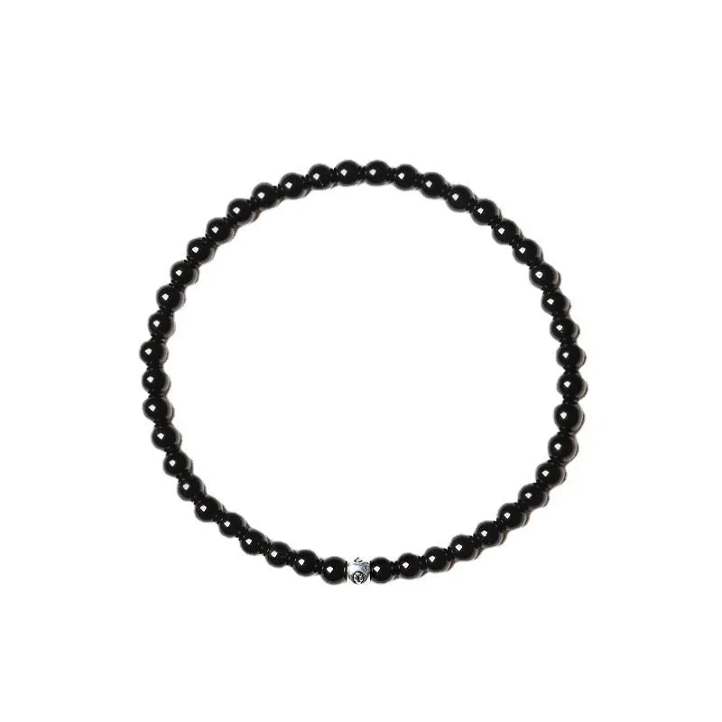 Geometric unisex bracelet with 4mm black agate, blue san, and obsidian beads on a wrist.
