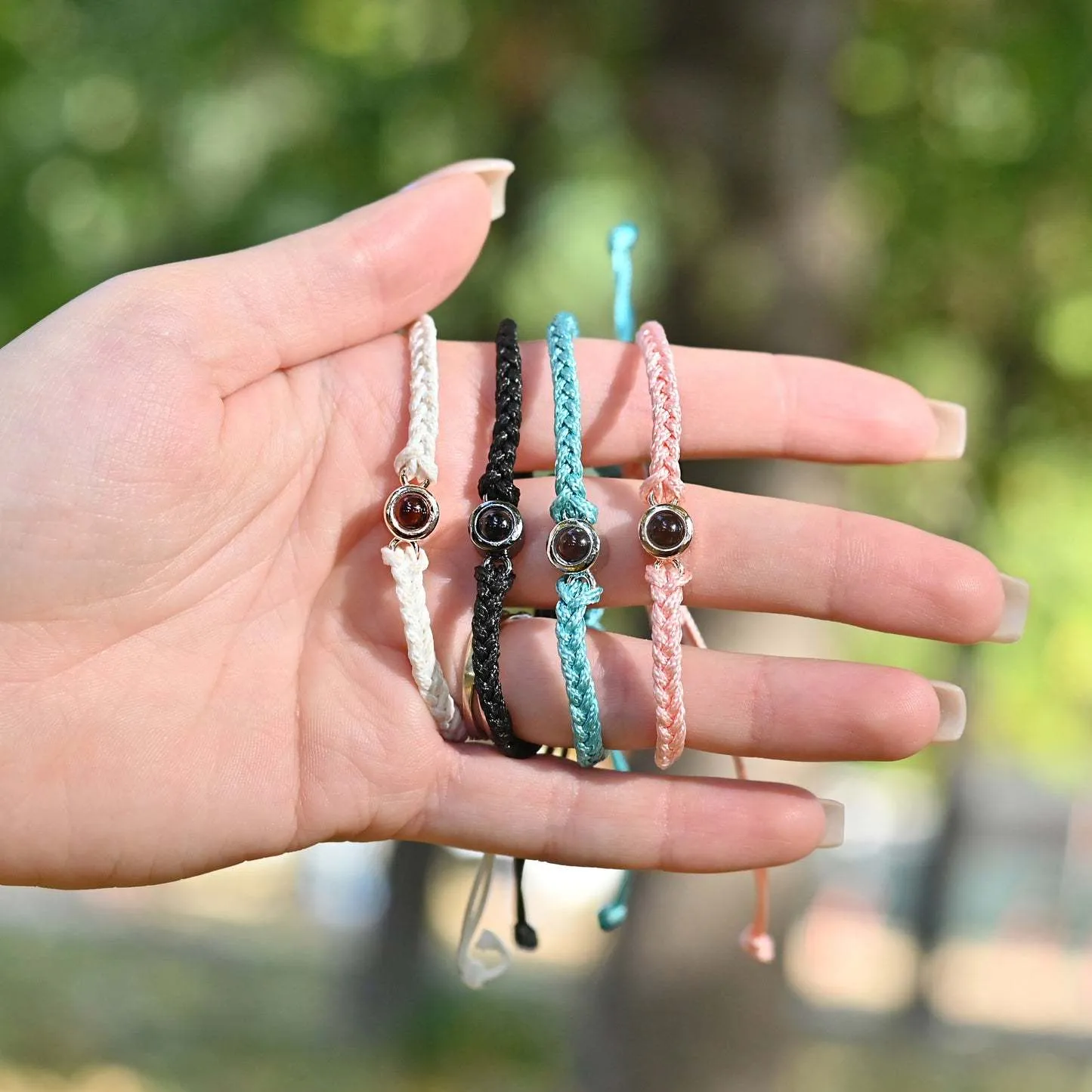 Handcrafted custom photo projection bracelet in silver with white rope, featuring alloy pendant with gold-plated inlaid artificial gemstones
