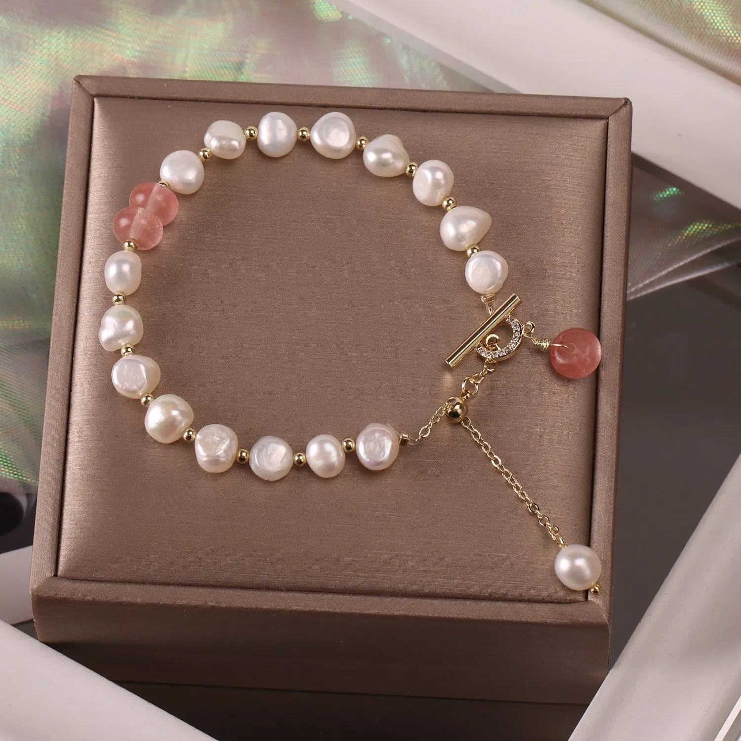Women's irregular freshwater pearl adjustable bracelet on a plain background showing the alloy clasp and irregular pearl beads