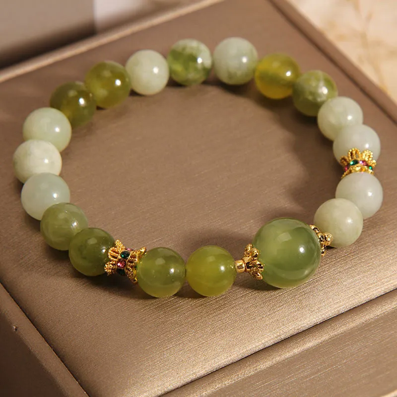 Xiuyan jade green women's bracelet with sweet Mori style design on a wrist.