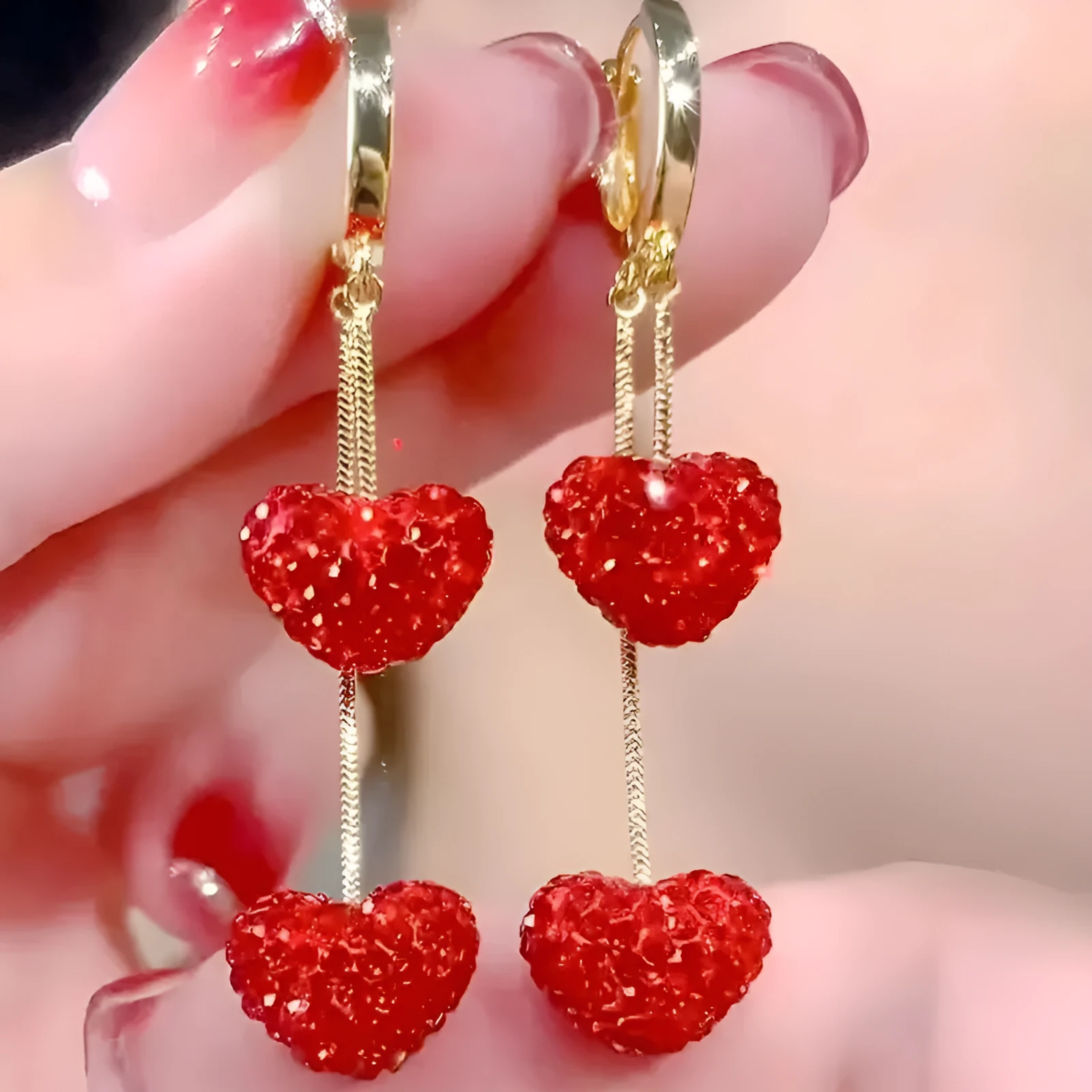 Red heart-shaped long earrings for women made of alloy with an electroplated finish, shown against a neutral background.