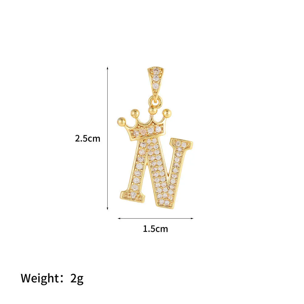 Gold plated copper letter A pendant with inlaid zircon crown and diamond cut surface on white background