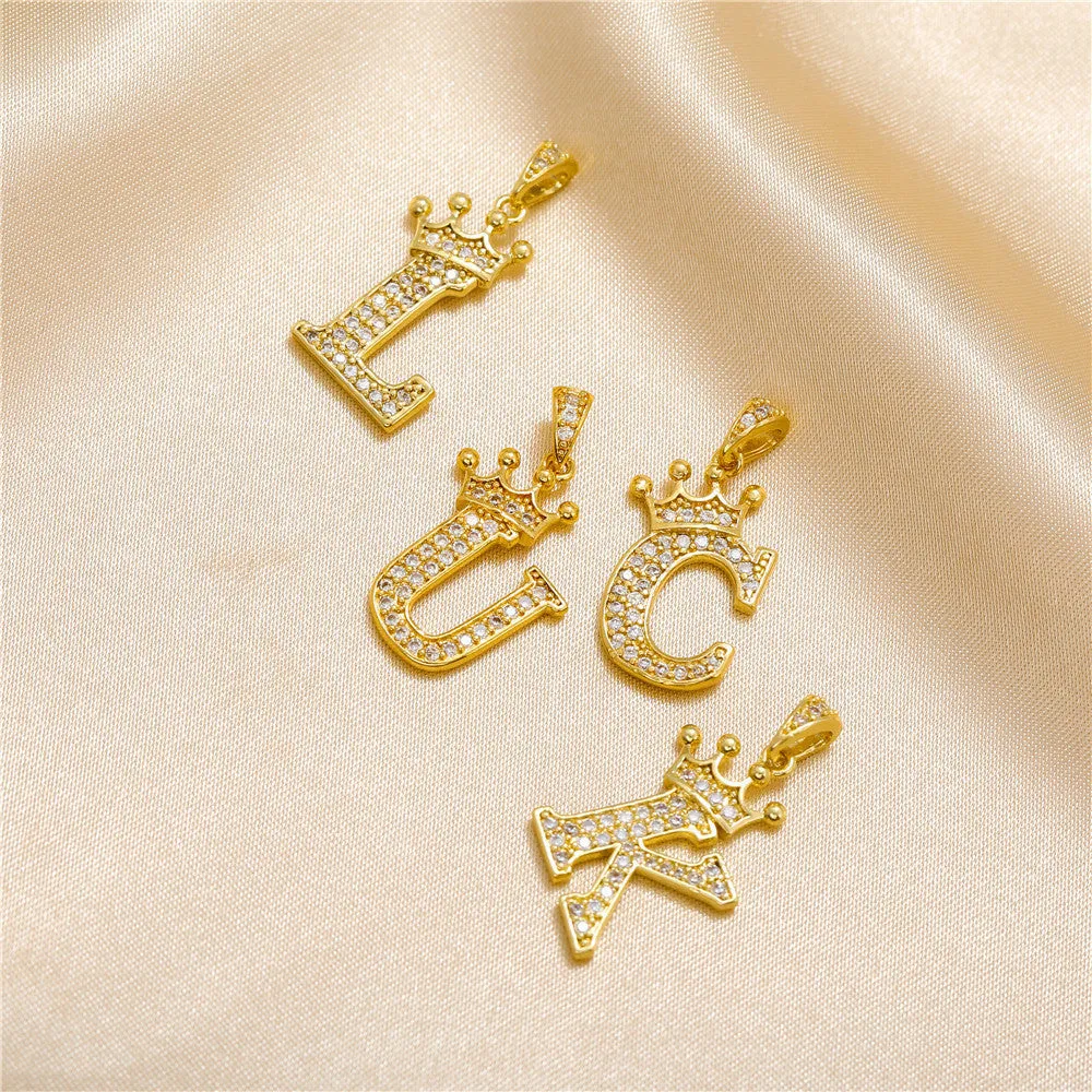 Gold plated copper letter A pendant with inlaid zircon crown and diamond cut surface on white background