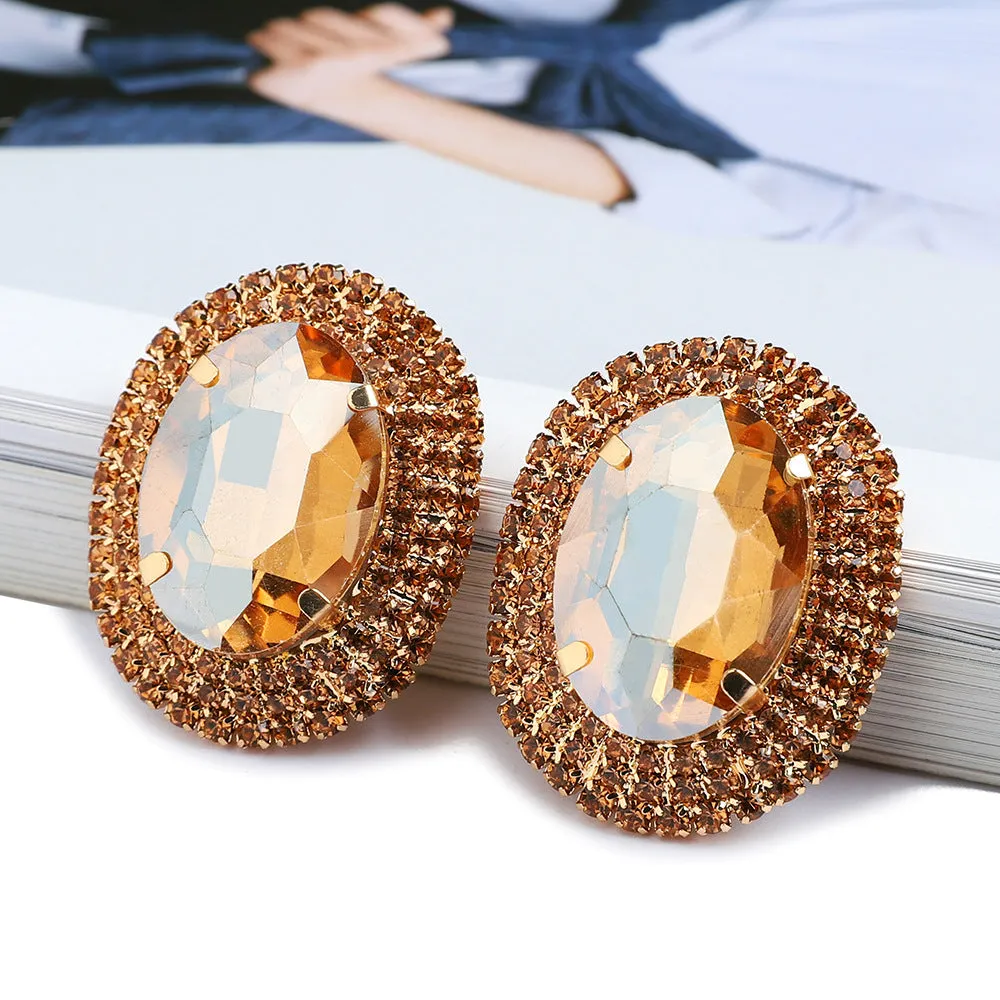 Women's oval rhinestone ear studs in eight colours including red, green, purple, black, white, pink, champagne, and AB finish