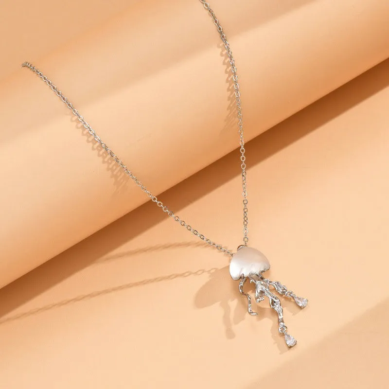 18K gold titanium steel openwork jellyfish pendant on silver O-ring chain against white background