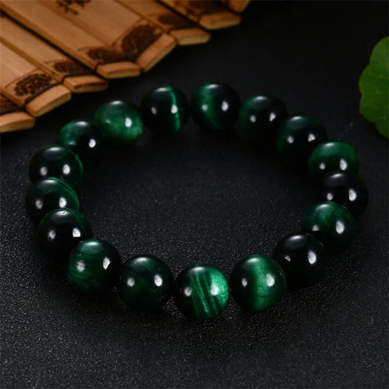 Green tiger eye stone bracelet with geometric shaped beads on a white background.
