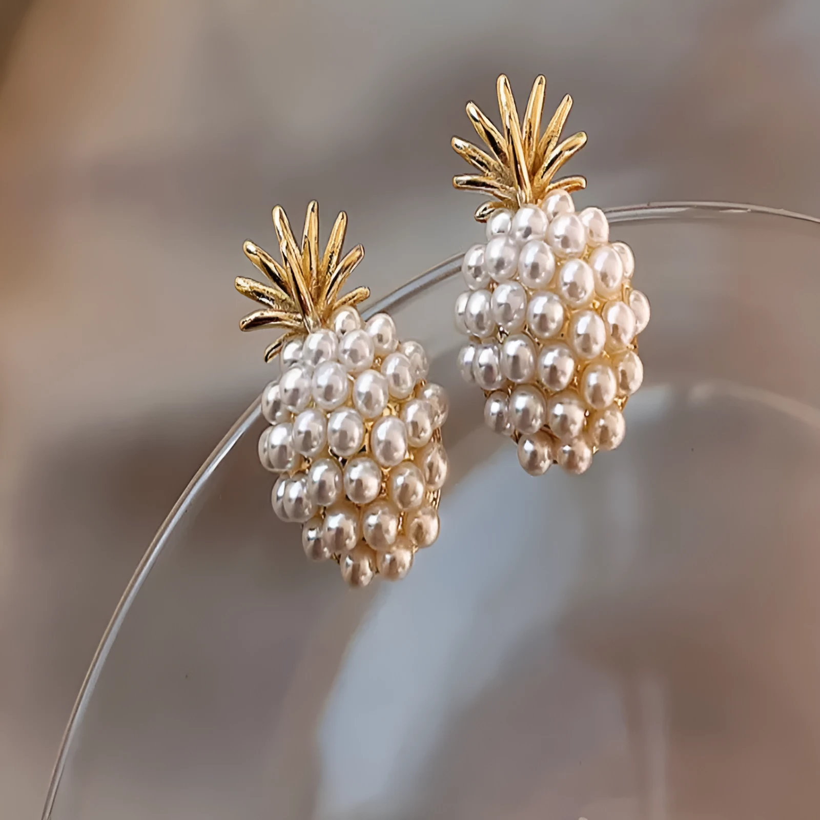 Korean style alloy earrings with pineapple and starfish motifs in gold colour, featuring inlaid artificial gems