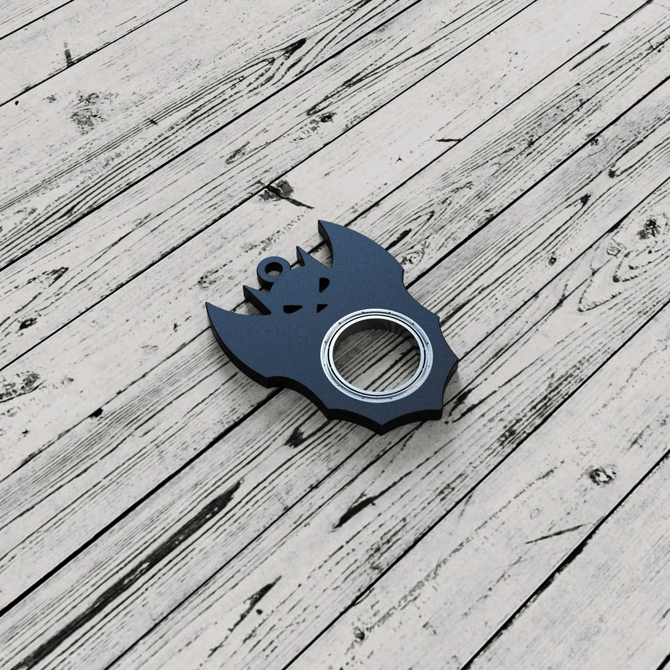 Black plastic Halloween bat demon ghost fidget spinner keychain with bottle opener on a dark background
