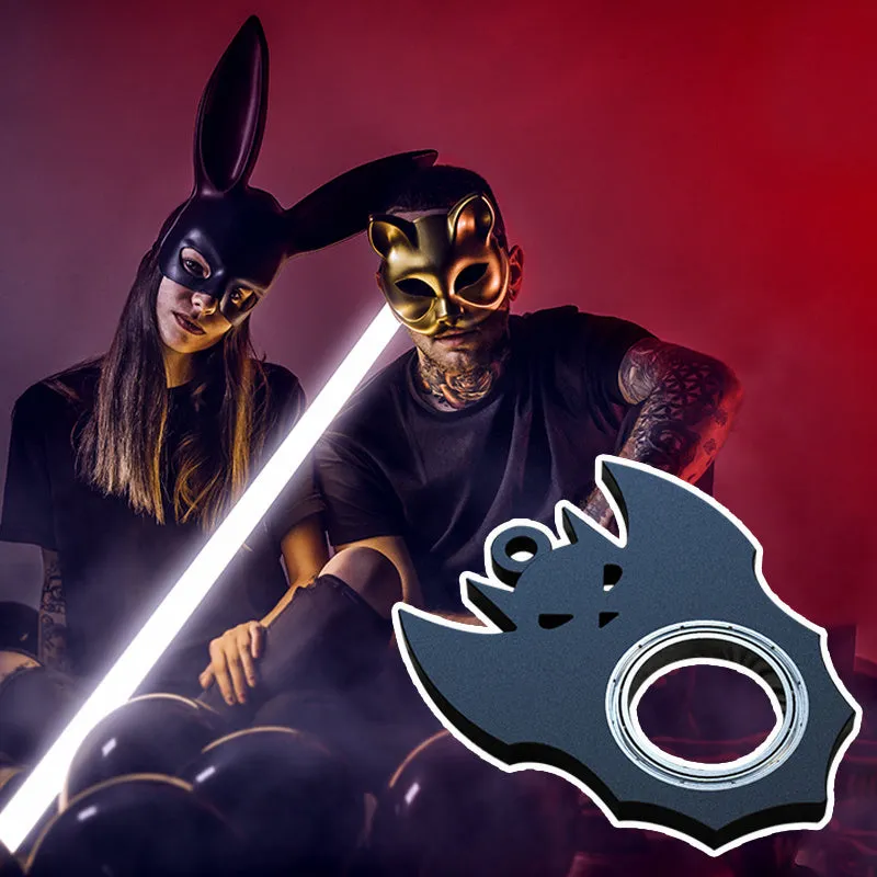 Black plastic Halloween bat demon ghost fidget spinner keychain with bottle opener on a dark background