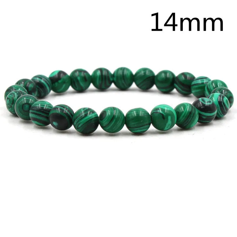 Malachite green and black matte 8mm round bead elastic strand bracelet on a neutral background